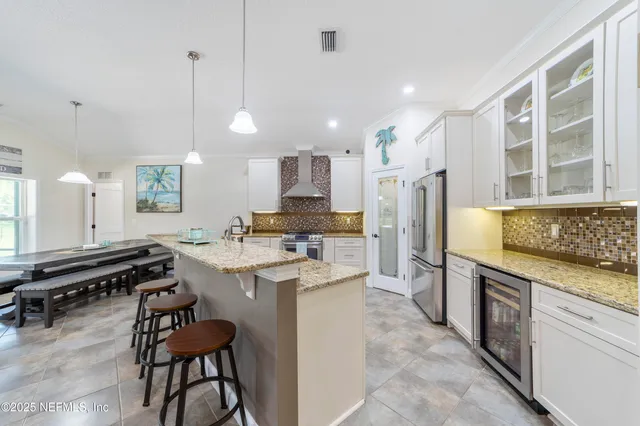 a spacious bedroom with a bed and a chandelier