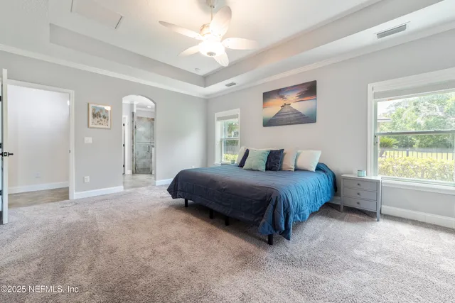 a bathroom with a granite countertop sink mirror vanity and toilet