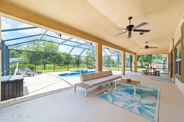 a living room with a large window and a table