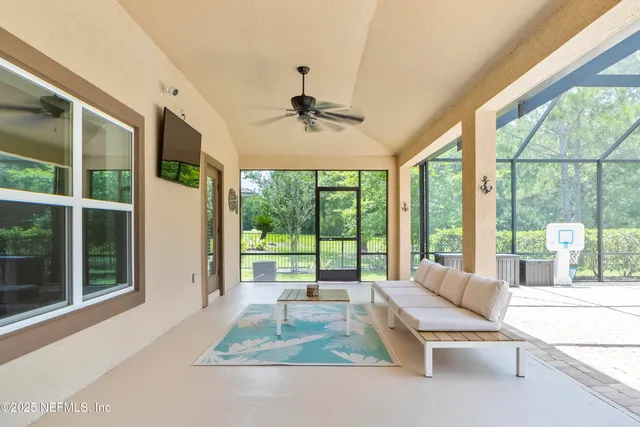 a view of a patio with a table chairs and a backyard