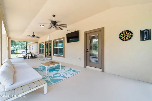 an aerial view of a house with a garden and lake view