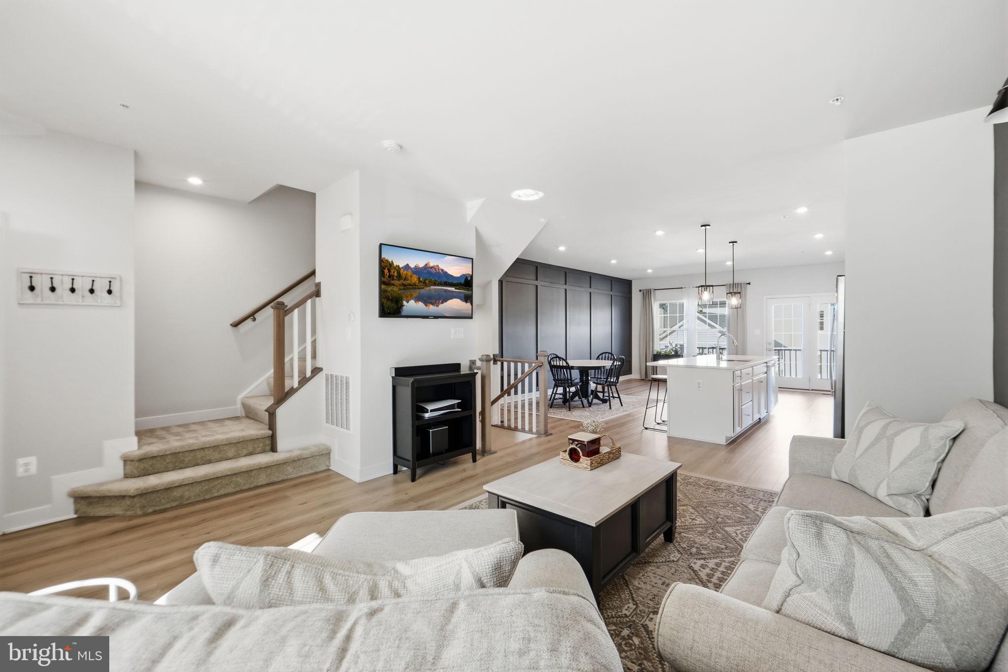 223 Edwin Road Frederick, MD 21702 - Photo 9 of 33 a living room with furniture a fireplace and a view of kitchen