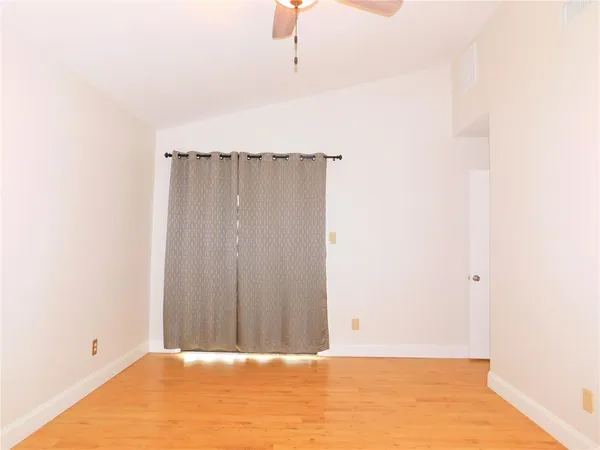 a view of a room with wooden floor