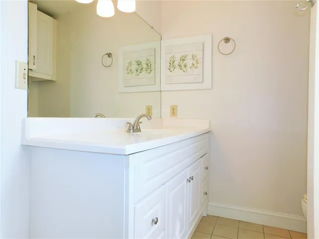 a bathroom with a sink a vanity and mirror