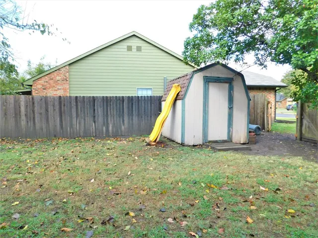 a view of a small house with a yard
