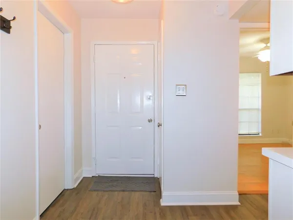 a view of a hallway with wooden floor