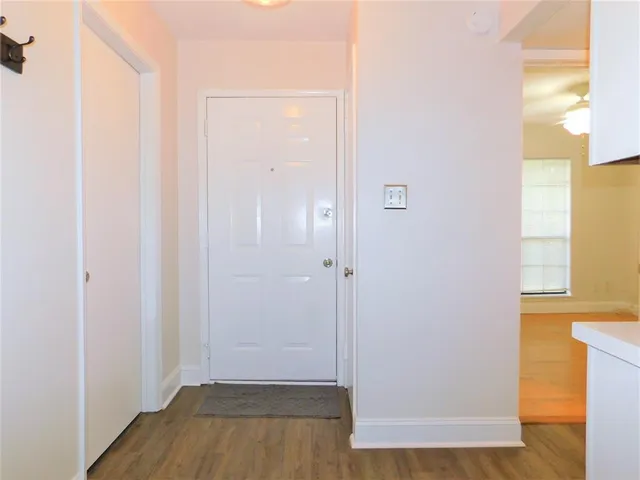 a view of a hallway with wooden floor