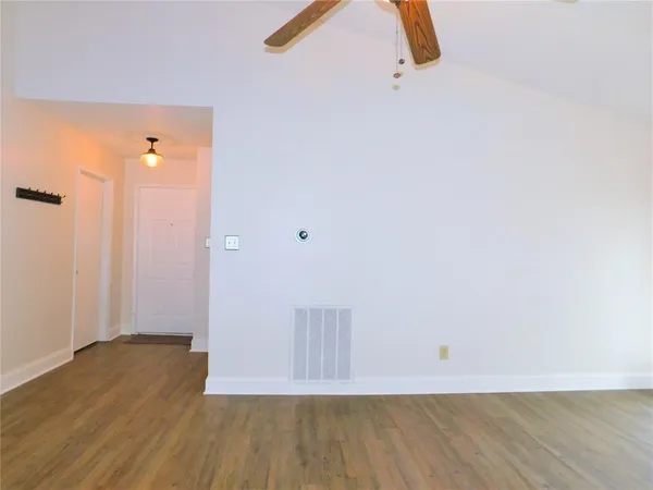 a view of a room with wooden floor