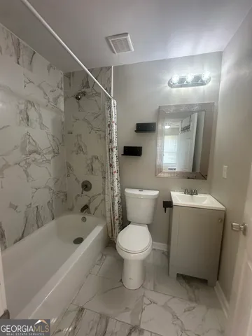 a bathroom with a bathtub toilet and sink