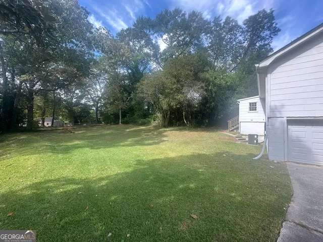 a view of outdoor space with deck and yard