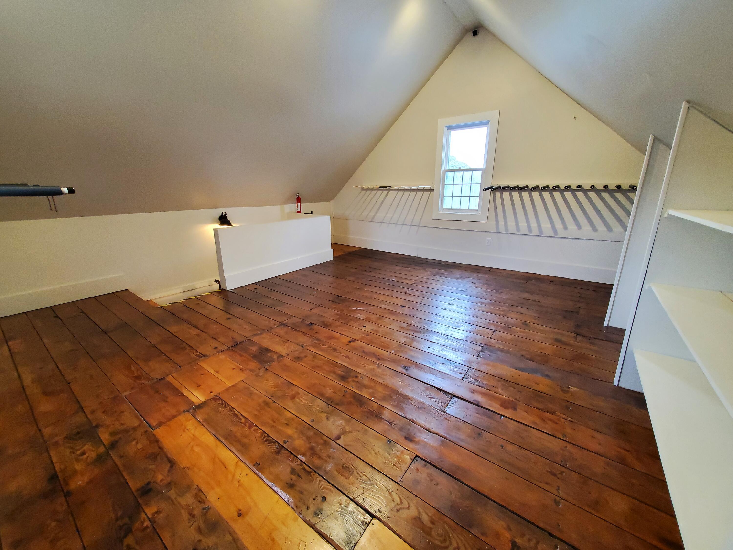 4900 State Highway Eastham, MA 02642 - Photo 9 of 16 a view of an empty room with wooden floor and stairs