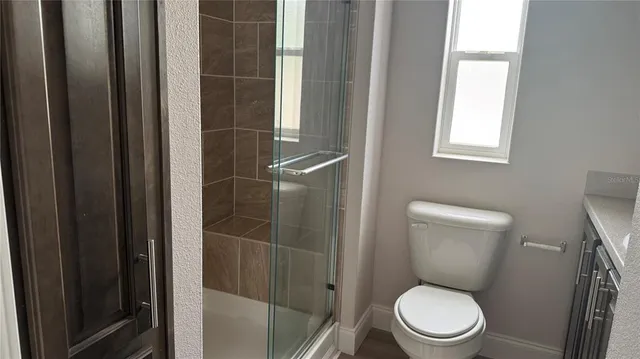 a white toilet sitting next to a bathroom sink