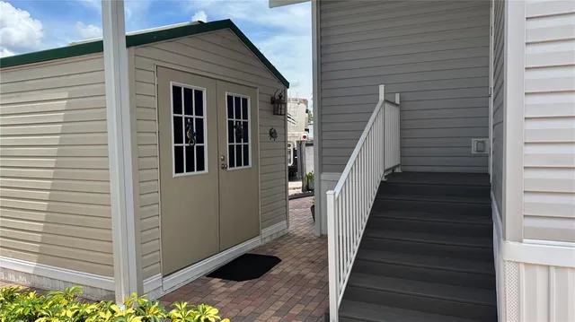 a view of a house with wooden walls and stairs