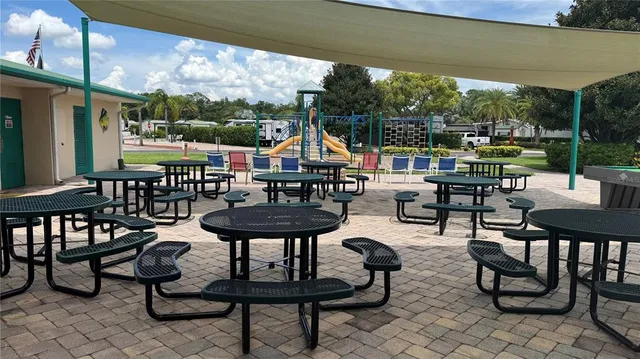 a view of lawn chairs under an umbrella