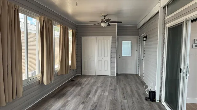 a view of a room with wooden floor and windows
