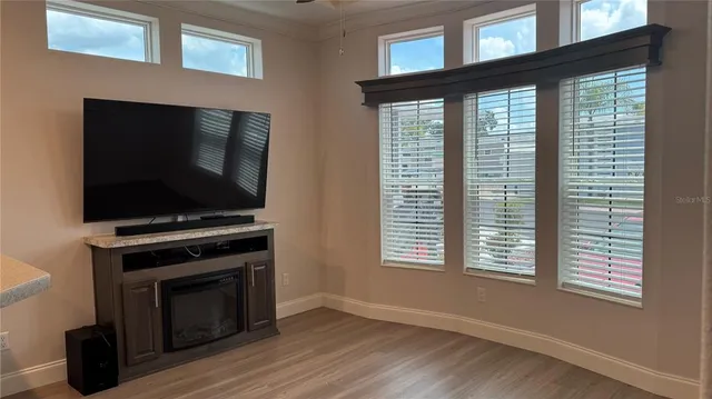 a living room with a flat screen tv and a fireplace