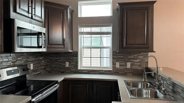 a kitchen that has a sink and a stove