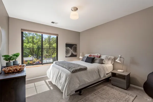 a bedroom with a bed and a large window