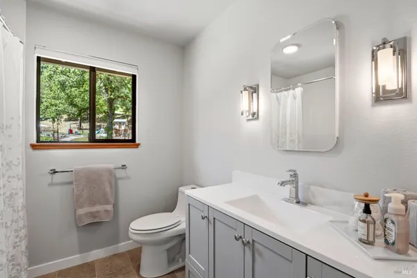 a bathroom with a toilet sink and mirror
