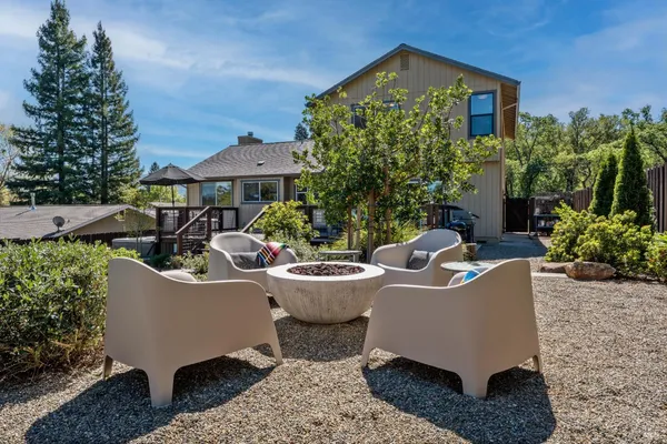a view of a house with backyard sitting area and garden