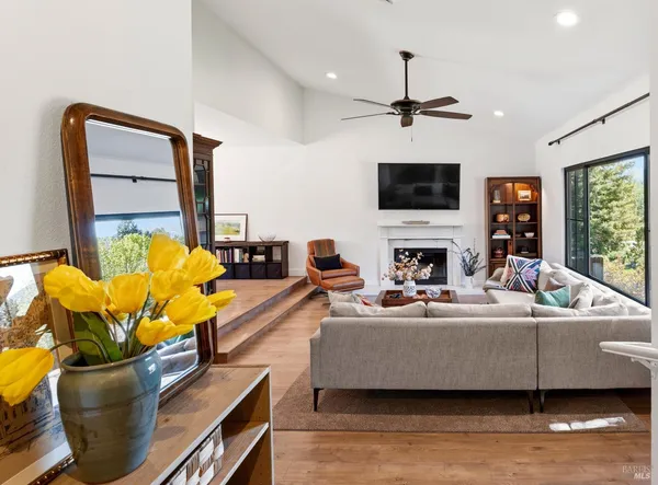 a living room with furniture fireplace and flat screen tv