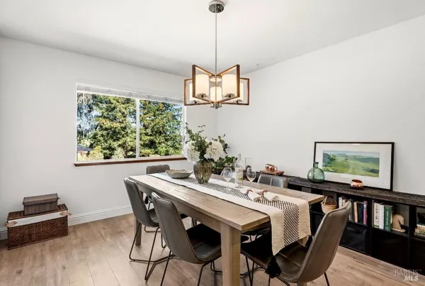 a view of a dining room with furniture window and wooden floor