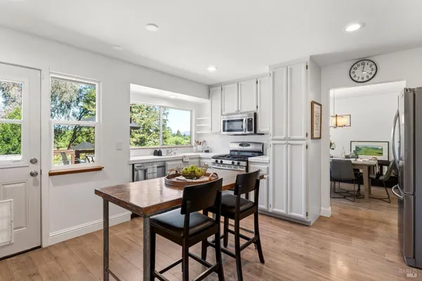 a view of a dining room with furniture and a window