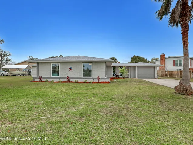 a front view of house with yard and trees