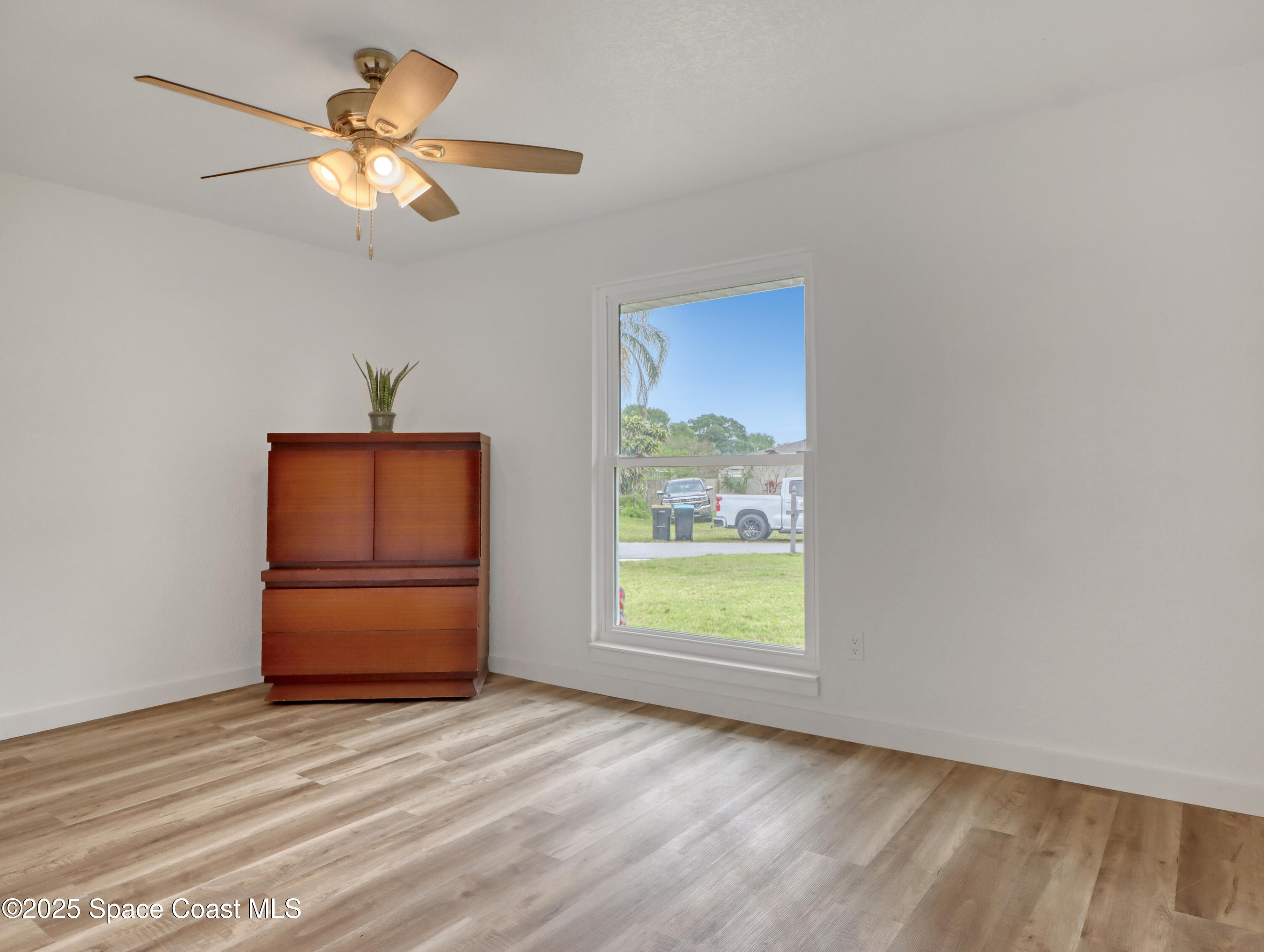872 Sadnet Circle Northeast Palm Bay, FL 32905 - Photo 15 of 21 an empty room with a window and a ceiling fan