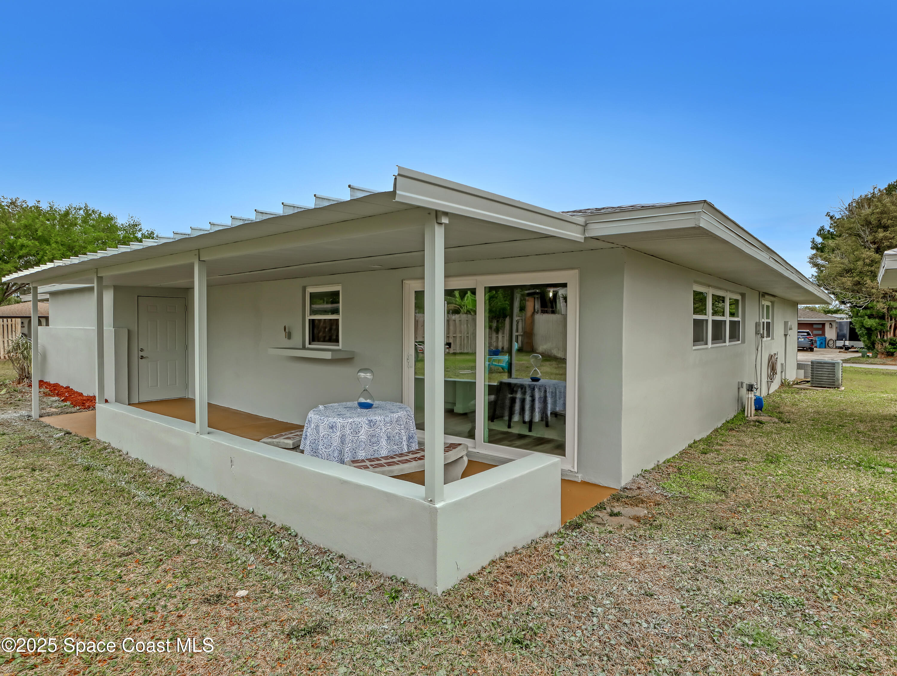 872 Sadnet Circle Northeast Palm Bay, FL 32905 - Photo 16 of 21 a front view of a house with garden