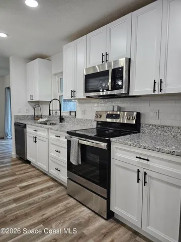 a bedroom with a bed mirror and a window