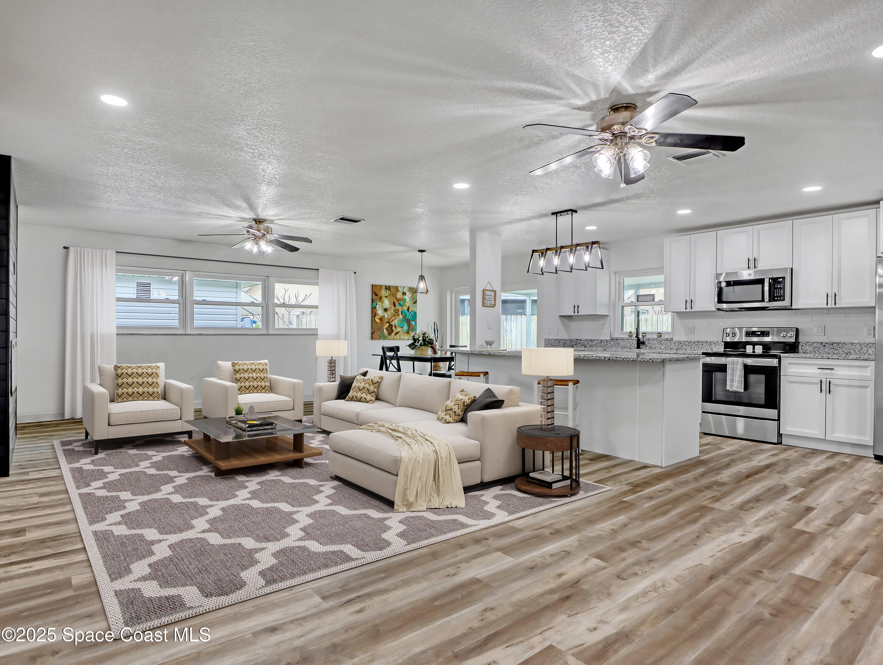 872 Sadnet Circle Northeast Palm Bay, FL 32905 - Photo 6 of 21 a living room with furniture and kitchen view