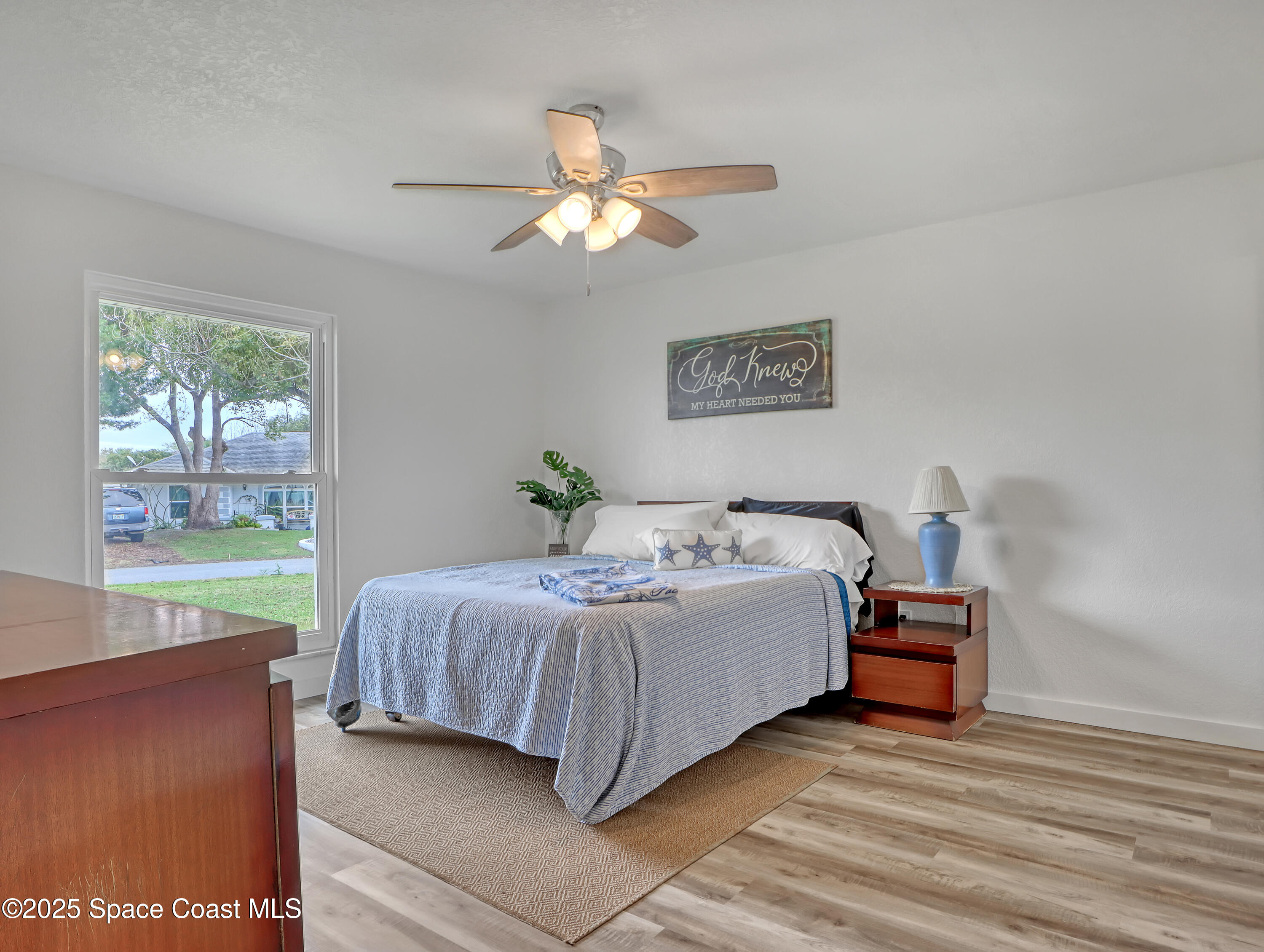 872 Sadnet Circle Northeast Palm Bay, FL 32905 - Photo 9 of 21 a spacious bedroom with a bed and a window