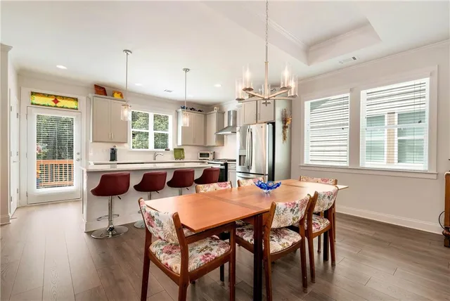 a view of a dining room with furniture and wooden floor
