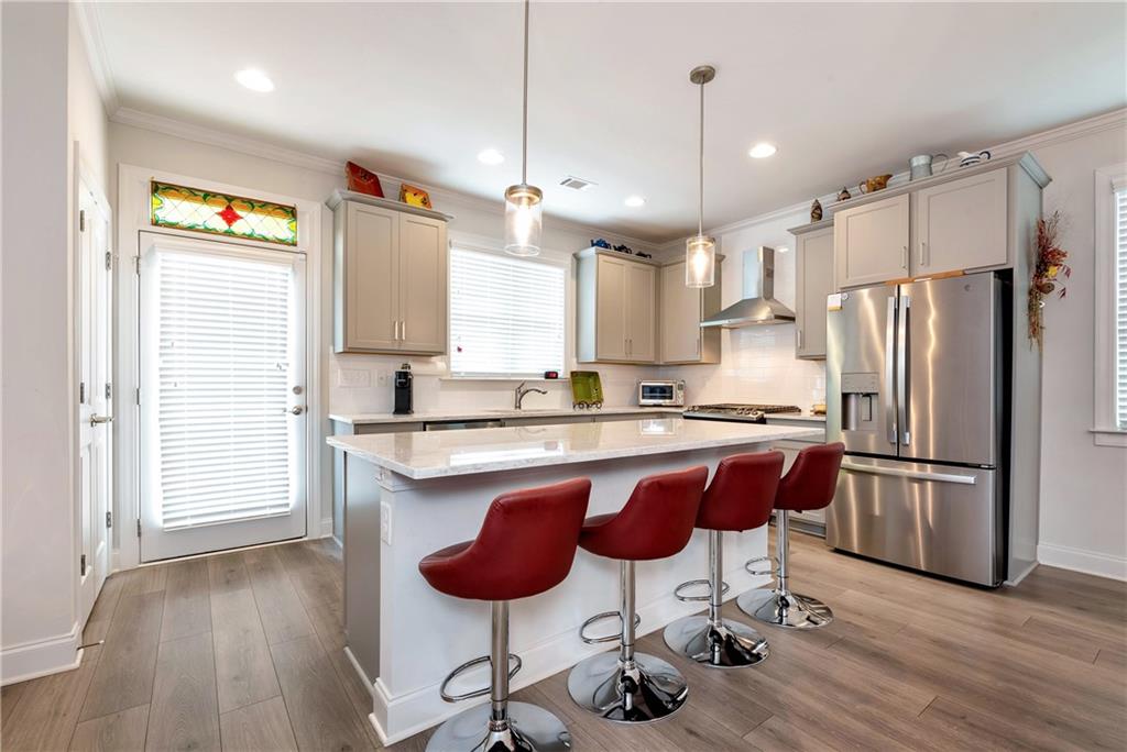 269 Grand Circle Jasper, GA 30143 - Photo 14 of 54 a kitchen with stainless steel appliances granite countertop a refrigerator a sink dishwasher a stove a dining table and chairs with wooden floor