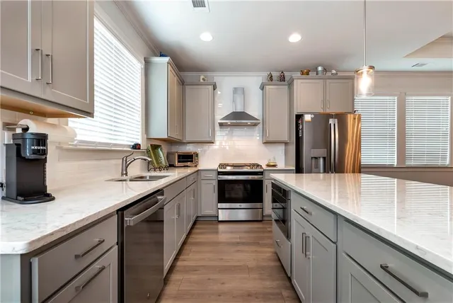 a kitchen that has a sink and a stove in it