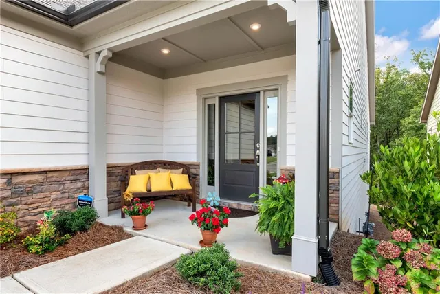a view of a hallway with wooden floor and a potted plant
