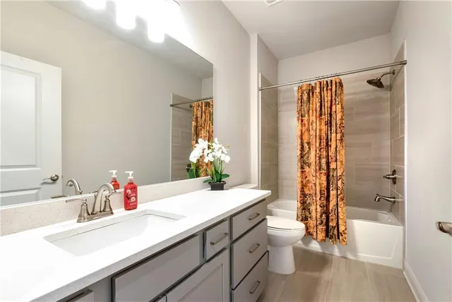 a view of a hallway with wooden floor and entryway