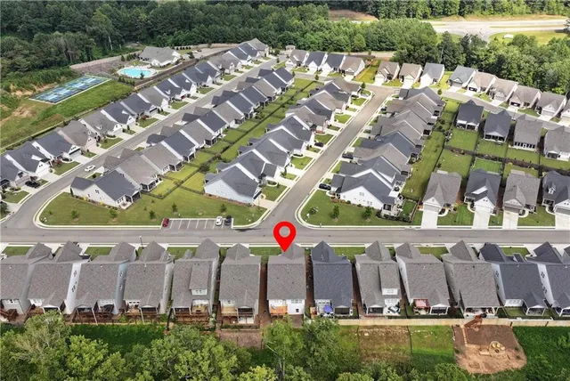 an aerial view of a house with a swimming pool