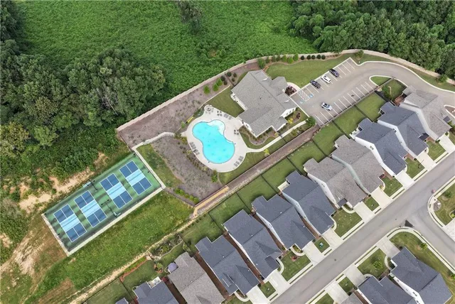 an aerial view of a residential apartment building with a yard