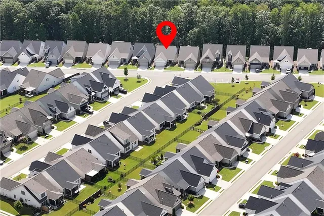 a aerial view of a residential apartment building with a yard