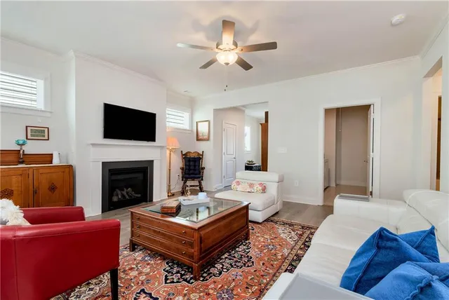 a living room with furniture a fireplace and a flat screen tv