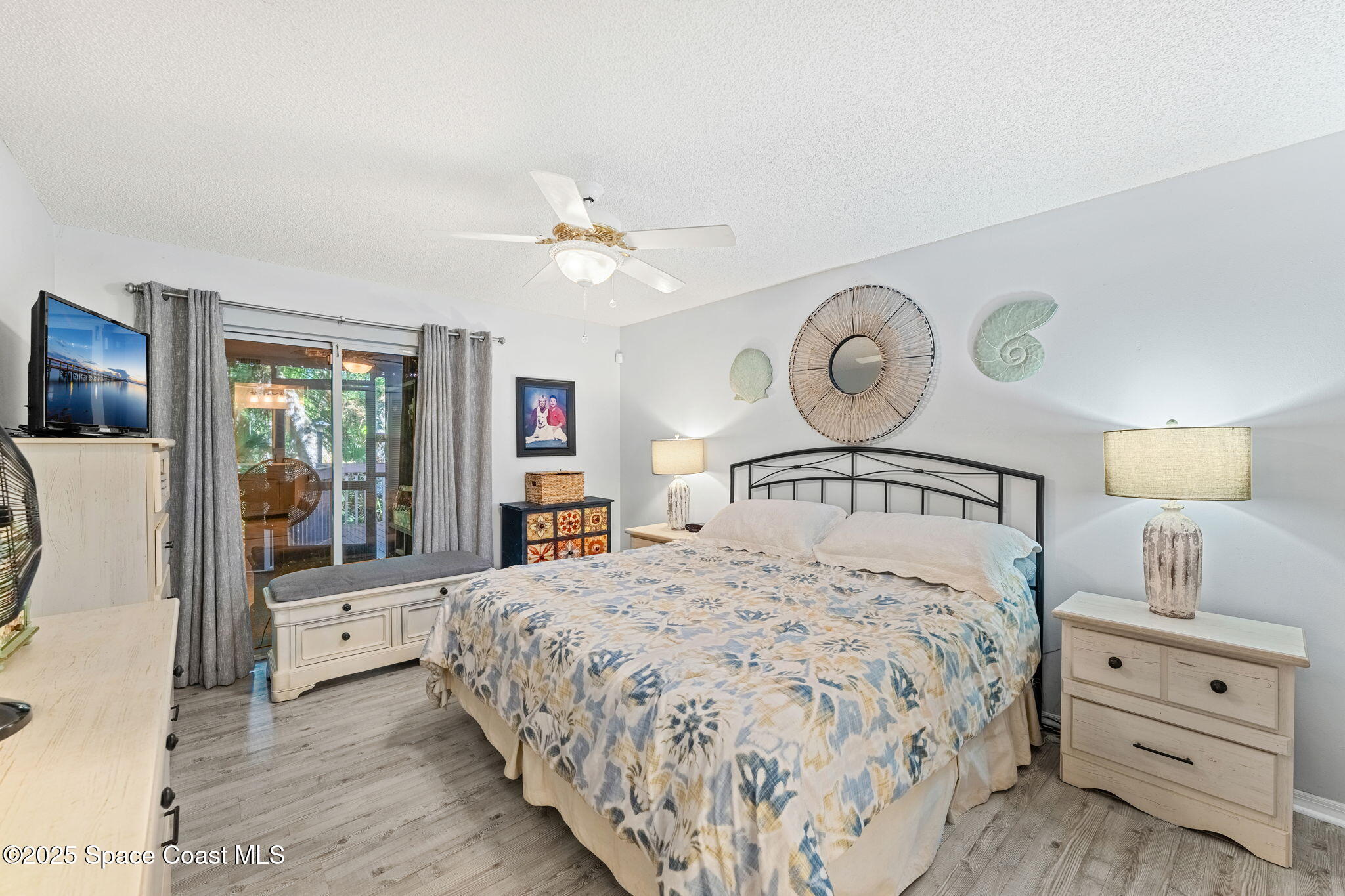 6205 Treetop Drive Melbourne Beach, FL 32951 - Photo 12 of 36 a bedroom with a large bed and a window
