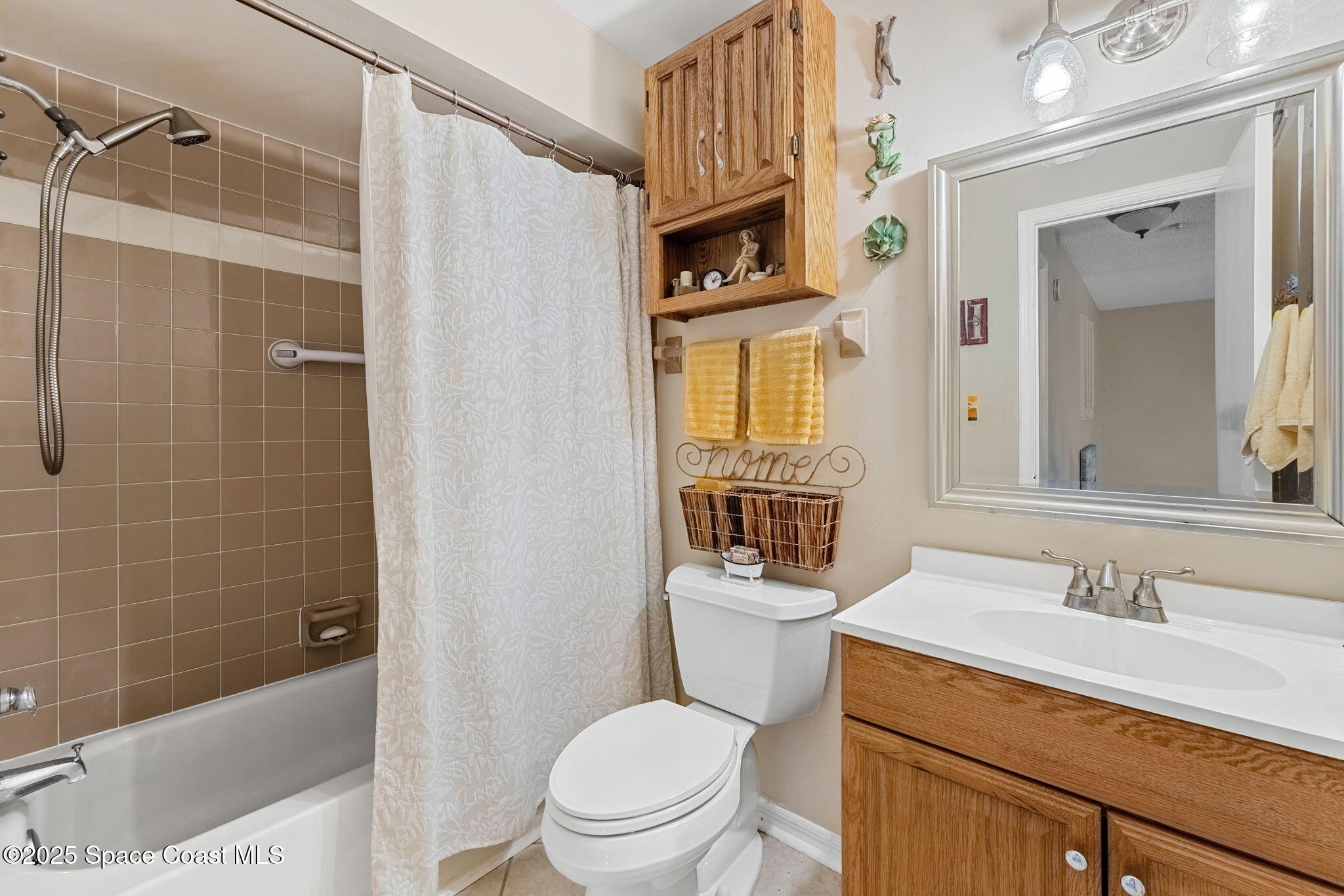 6205 Treetop Drive Melbourne Beach, FL 32951 - Photo 16 of 36 a bathroom with a sink a toilet and shower