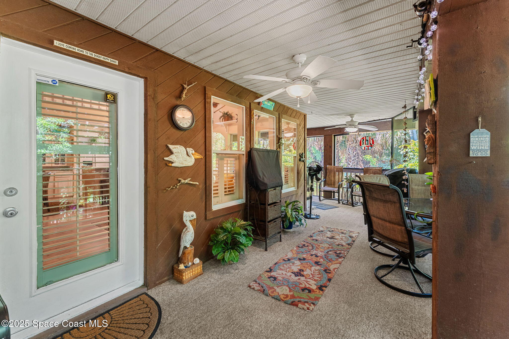 6205 Treetop Drive Melbourne Beach, FL 32951 - Photo 21 of 36 a view of a livingroom with furniture and windows