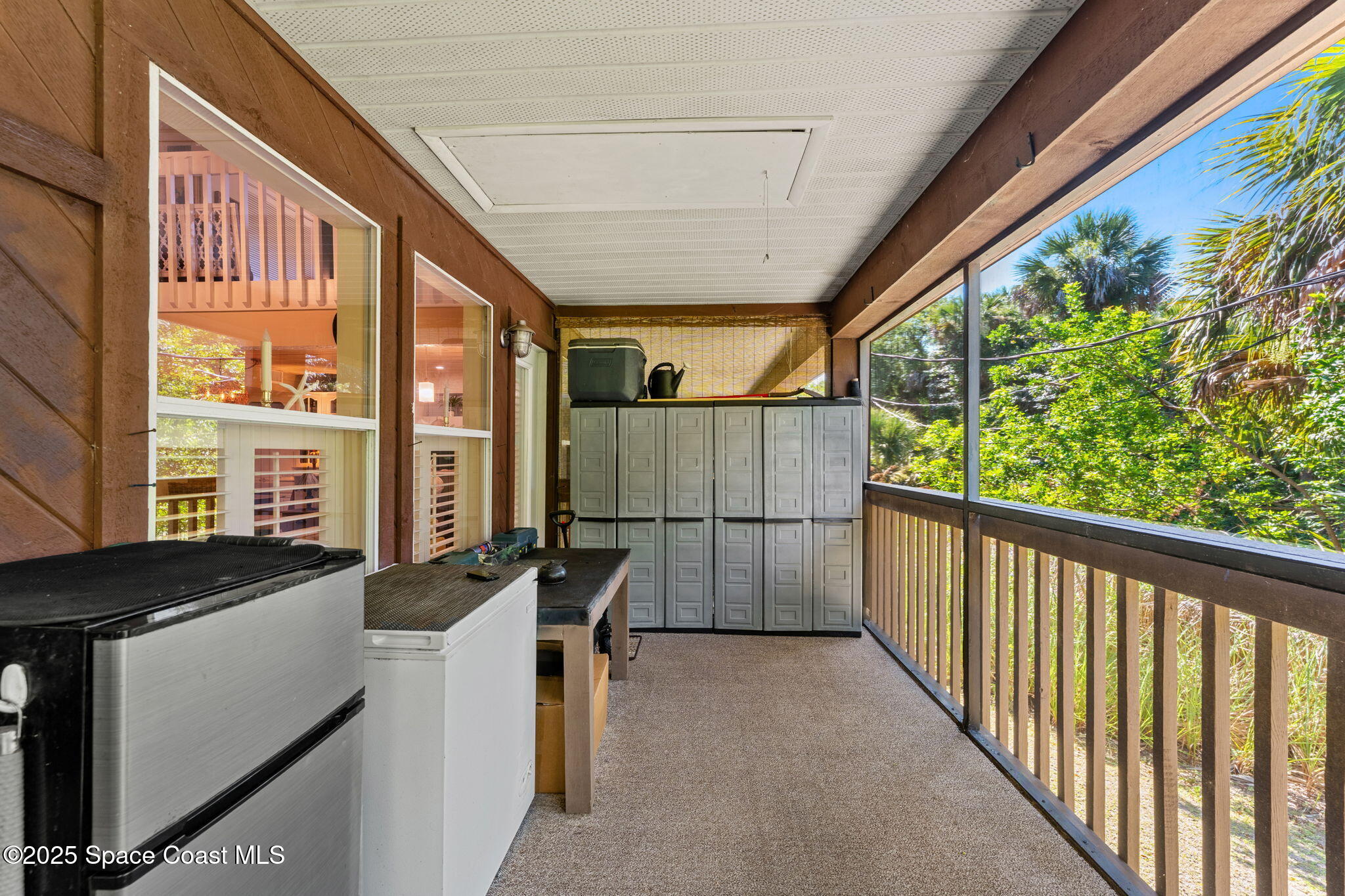 6205 Treetop Drive Melbourne Beach, FL 32951 - Photo 22 of 36 a view of a porch with furniture