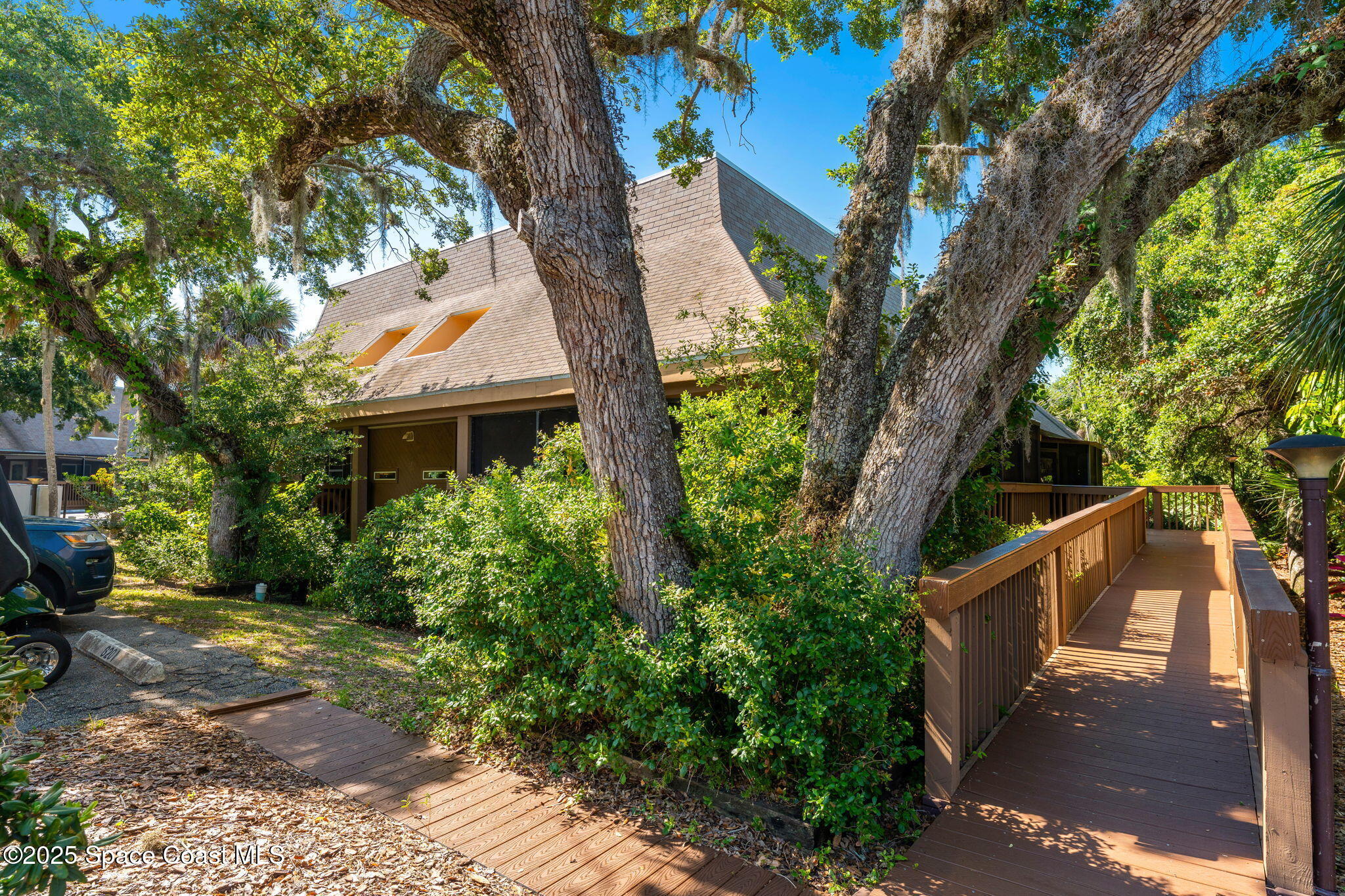 6205 Treetop Drive Melbourne Beach, FL 32951 - Photo 26 of 36 a front view of a house with garden