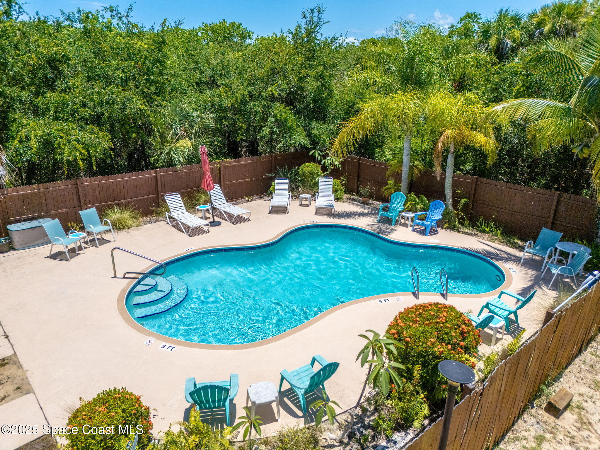 6205 Treetop Drive Melbourne Beach, FL 32951 - Photo 29 of 36 a view of a swimming pool with a patio and a garden