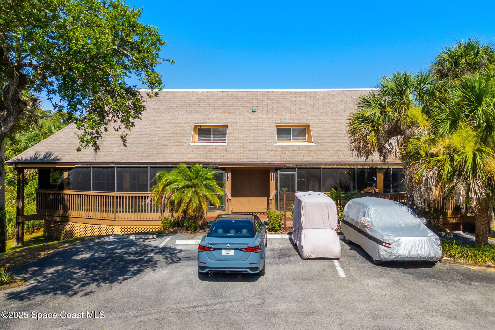 6205 Treetop Drive Melbourne Beach, FL 32951 - Photo 32 of 36 a car parked in front of a house