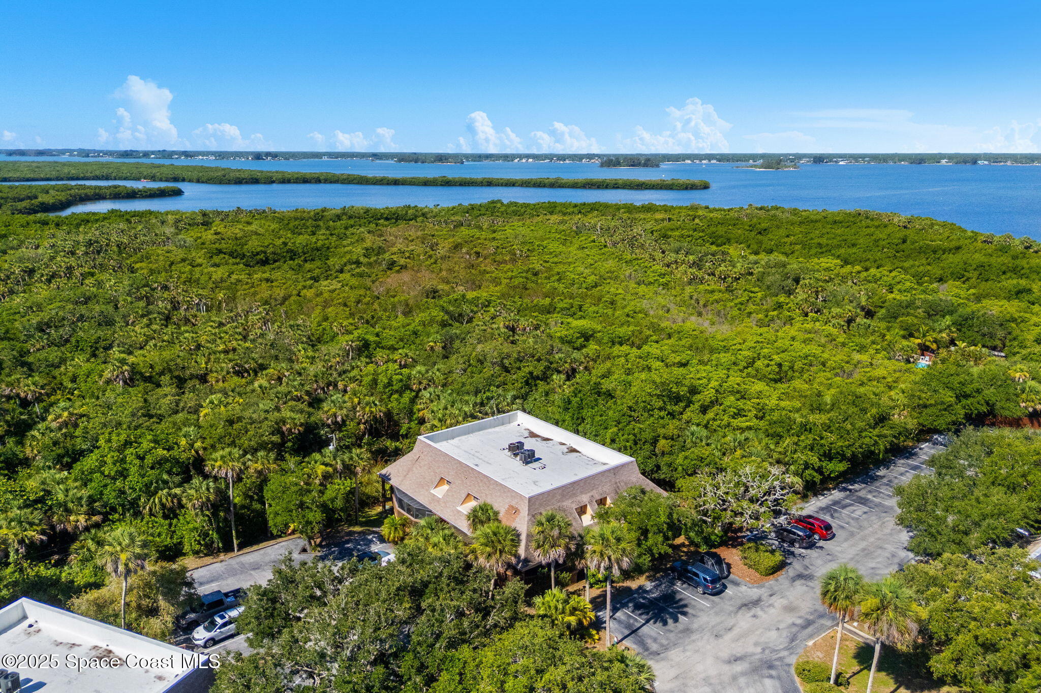 6205 Treetop Drive Melbourne Beach, FL 32951 - Photo 33 of 36 a view of a lake with a house in background